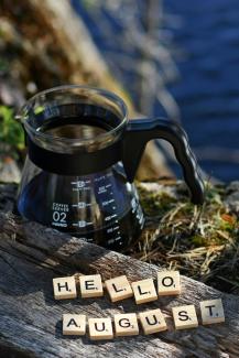 a coffee pot with scrabbles spelling hello august by Elin Melaas courtesy of Unsplash.