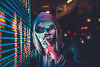 person standing near LED sign by Max Bender courtesy of Unsplash.