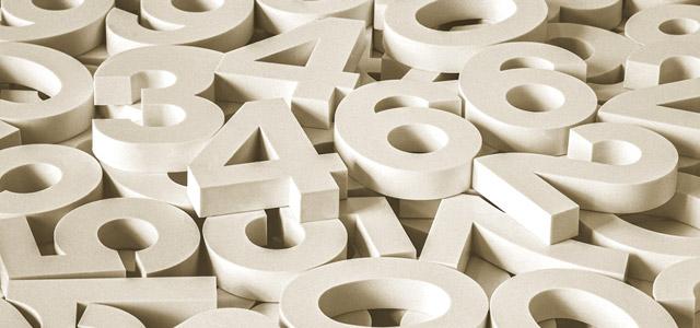 A scattered pile of large white 3D numbers overlapping one another.
